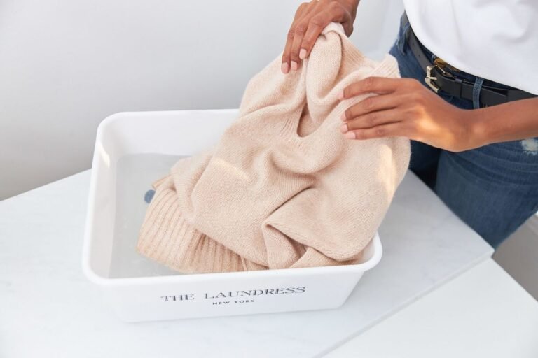 Hand-washing a beige cashmere jumper — specialist cashmere dry cleaning in Sydney