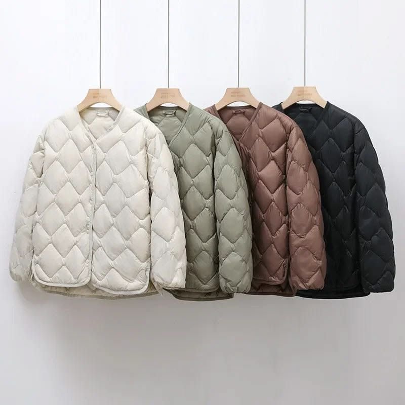 Row of quilted puffer jackets on hangers — specialist puffer jacket cleaning Sydney