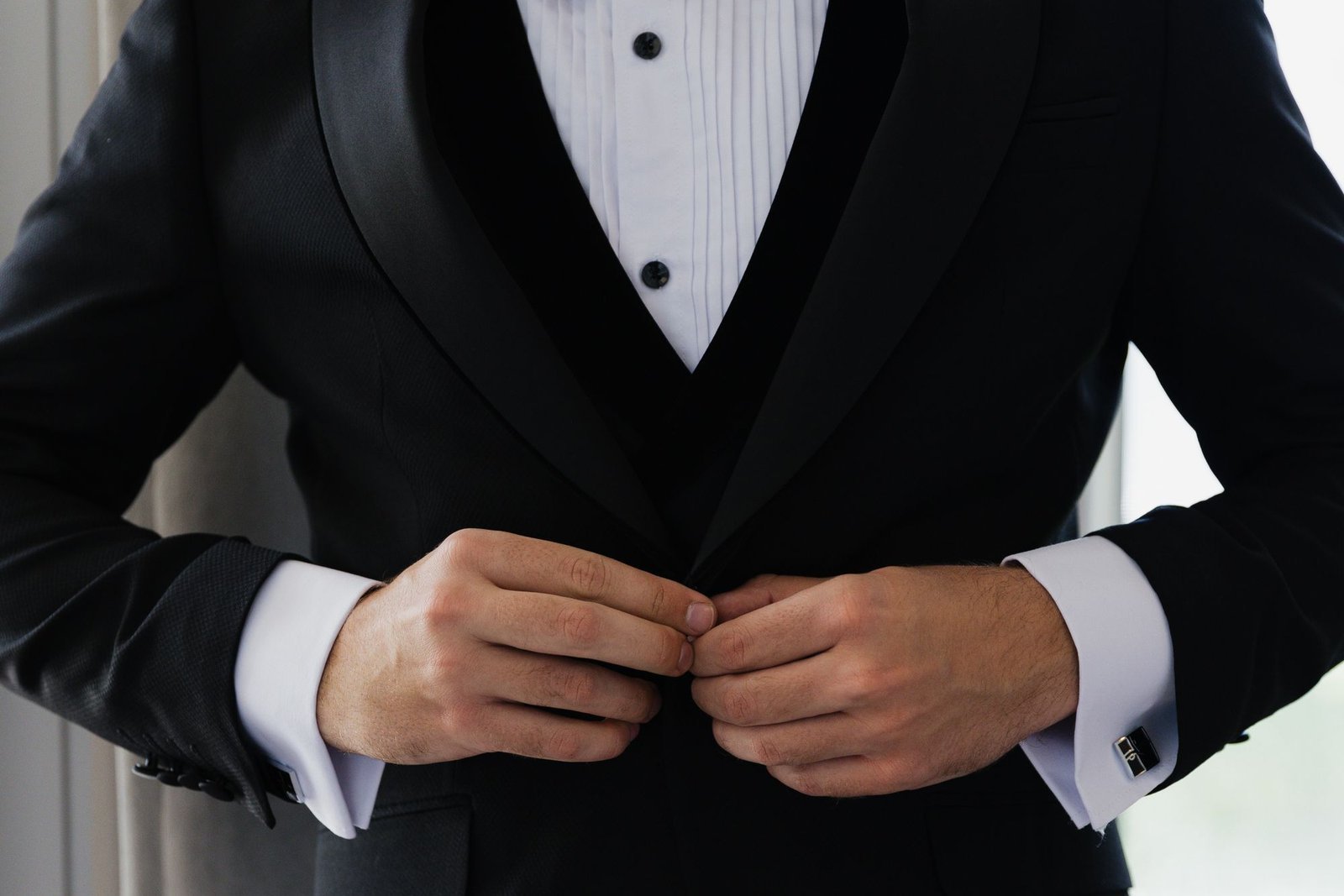 A white dinner jacket and black bow tie marked by spilt champagne after a gala, illustrating tuxedo dry cleaning in Sydney